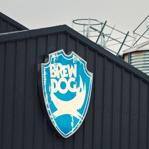 The BrewDog shield emblem on the side of the brewery